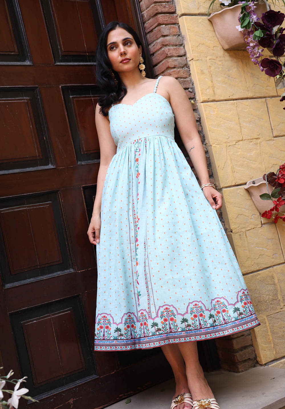 Full-length view of Birdsong printed maxi dress near doorway