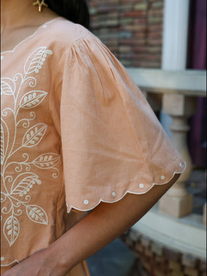 Close-up of embroidered sleeve detail on fawn coord set
