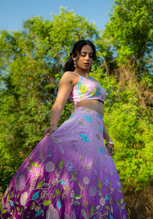 Close view of floral embroidery and purple shades on the lehenga skirt