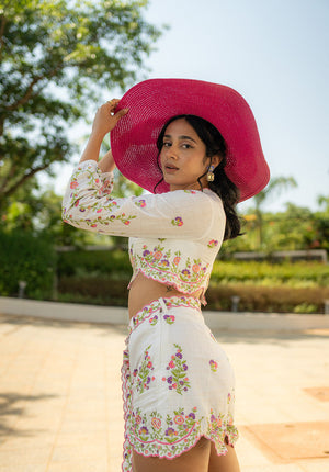 Model in floral embroidered top and shorts, captured from a side pose — perfect for summer looks
