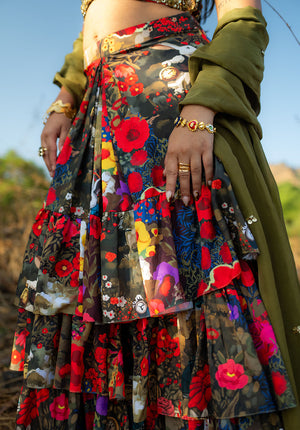 Model wearing floral printed gathered skirt with golden bangles.