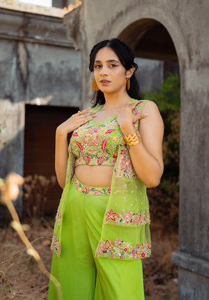 Full outfit view highlighting the embellished blouse, layered net jacket, and coordinating sharara.