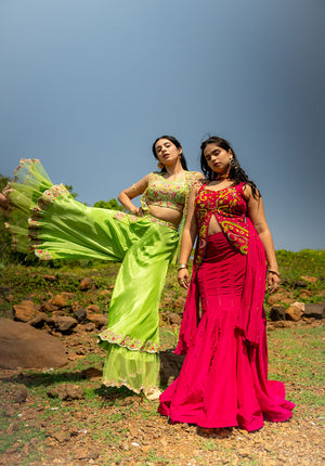 Two models wearing green sharara sets in different silhouettes and colors, giving standing pose.