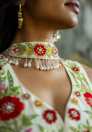 Embellished dupatta with tassels paired with a curved V neckline kurti.