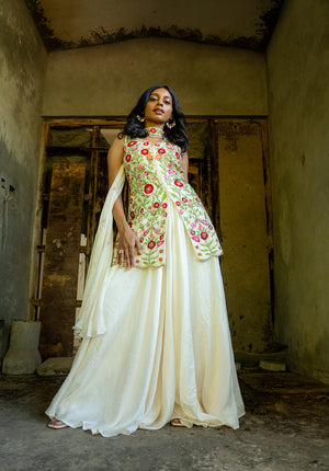 Model flaunting floral embellished kurti paired with plain sharara and matching dupatta for a graceful traditional look.