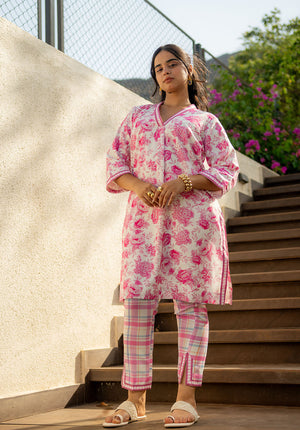 Model standing on stairs wearing printed kurta and pant set, ideal for everyday wear.