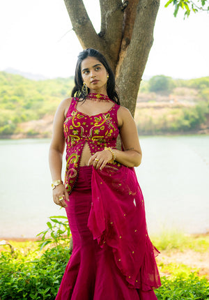 Model standing near a tree wearing matching lehenga set with blouse, skirt, and dupatta in a coordinated design.