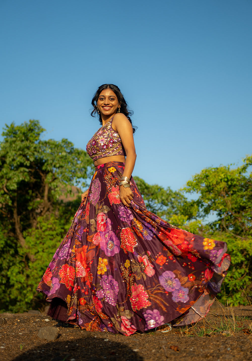 Model showcasing matching lehenga blouse and skirt with golden bangles for an elegant festive look.