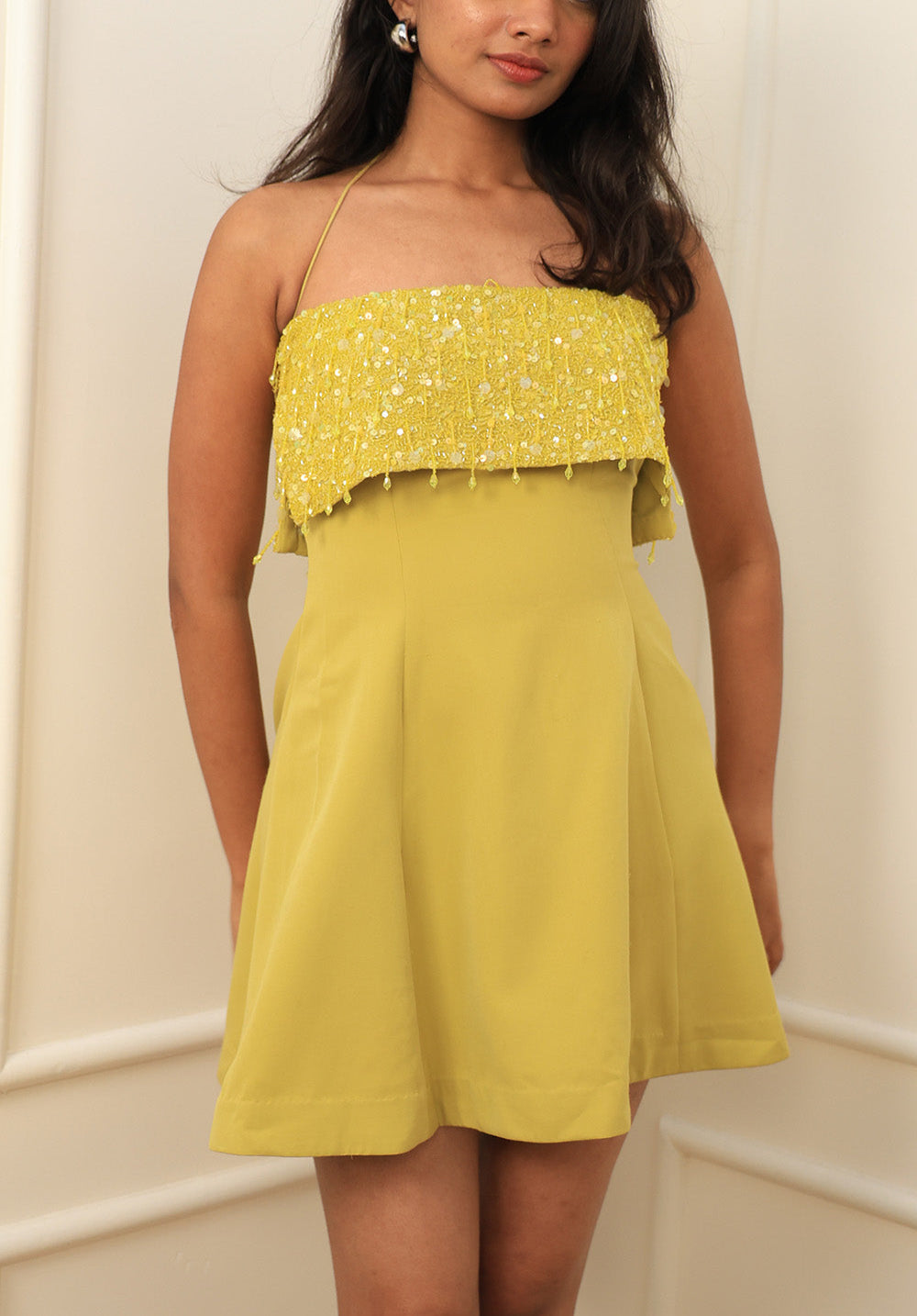 Model wearing the Limoncello Sequin Halter Mini Dress in lime green, front view, embellished bodice with A-line skirt.