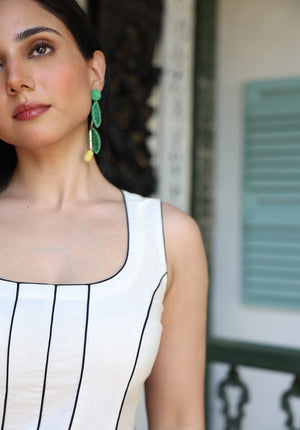 Close-up of square neckline and black piping detail on ivory Parasio dress