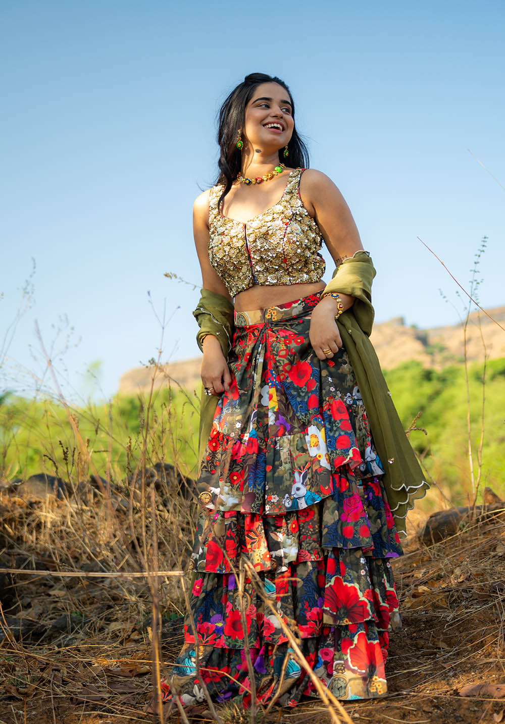 Model in printed skirt and fully embellished blouse with a contrasting dupatta.