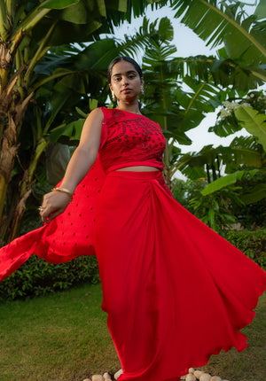 Red lehenga with drape-effect skirt and matching blouse, perfect for elegant traditional occasions.