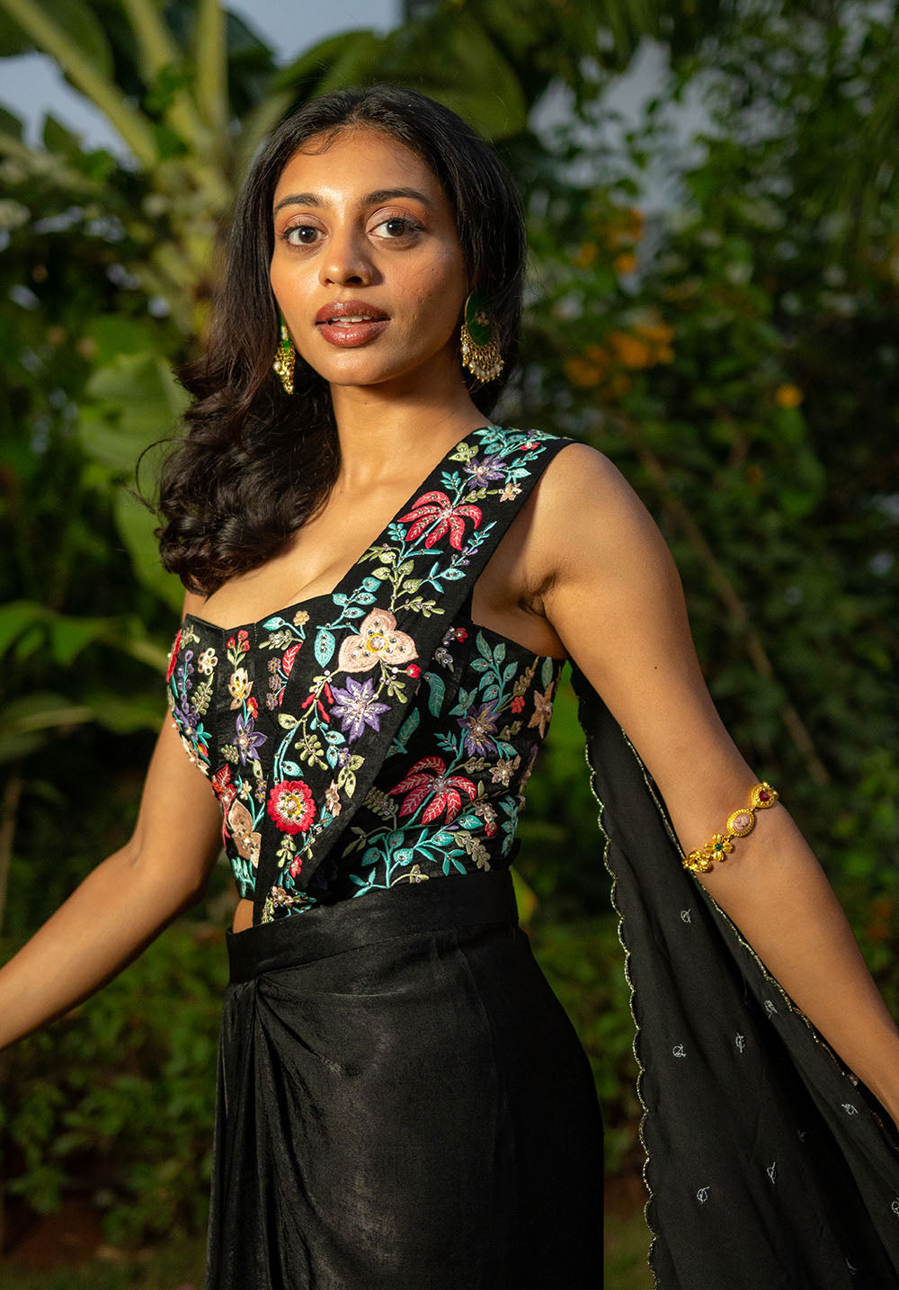 Side view of model in saree fusion showcasing floral embroidered pallu and matching blouse.