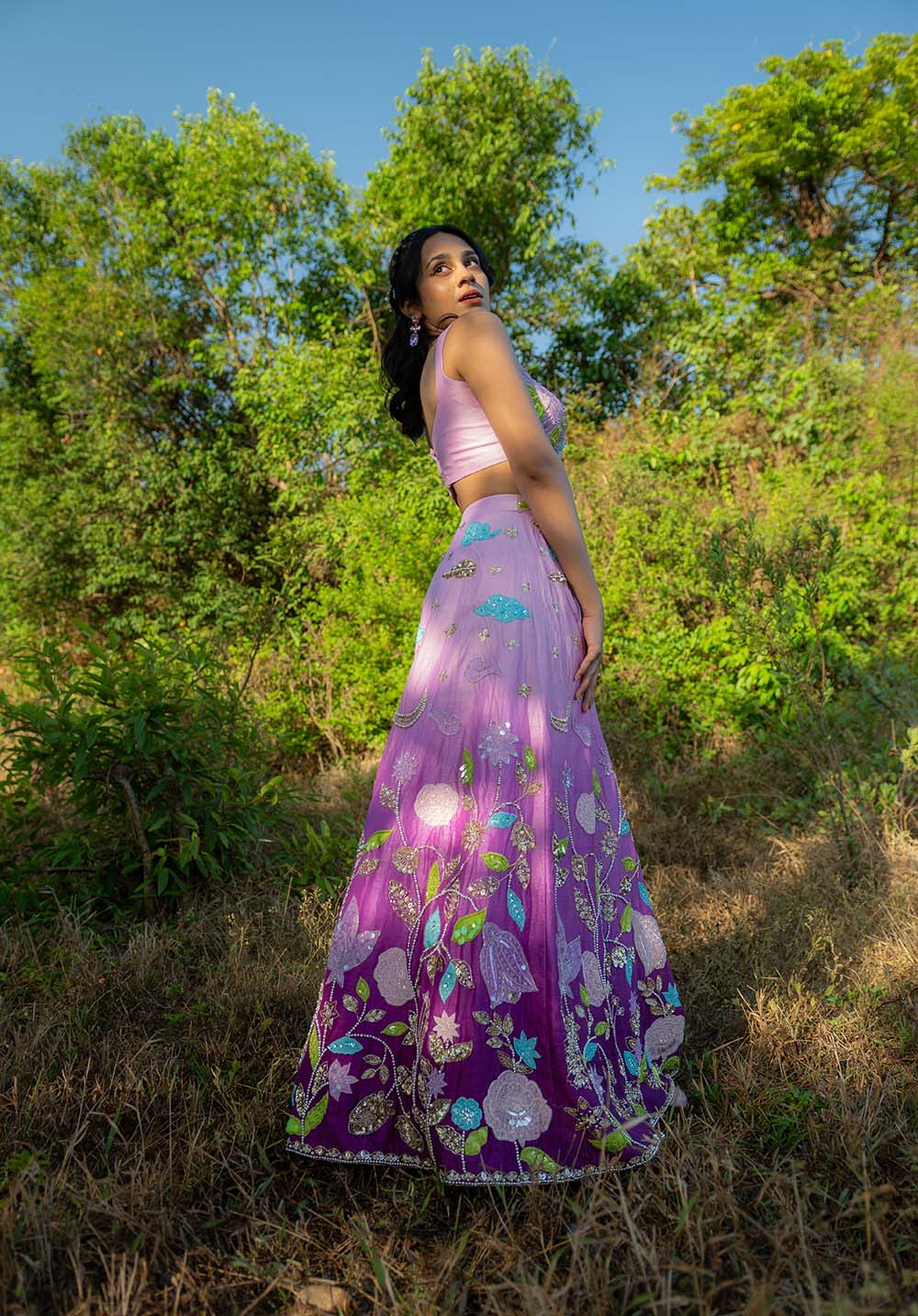 Side pose showing perfect coordination of floral embroidered blouse and skirt