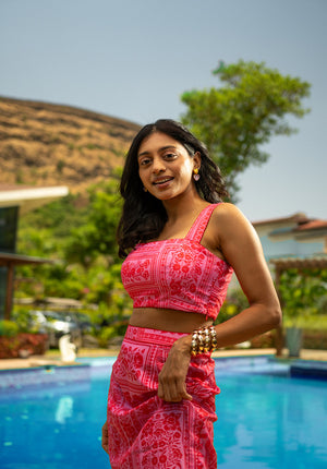 Model in a sleeveless printed pink top — fresh and playful for sunny days.