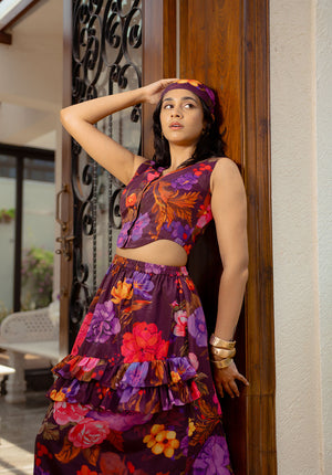 Model in sleeveless floral print waistcoat with matching scarf — a polished and coordinated outfit.