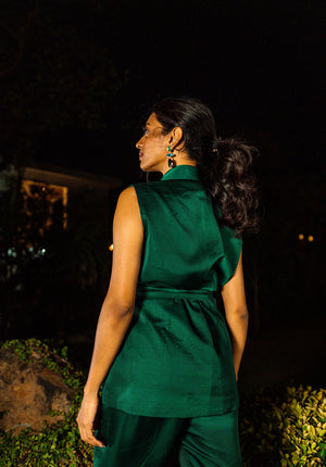 Back view of the model in a green sleeveless jacket