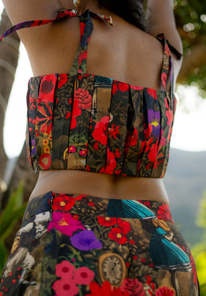 Close-up back pose of the model in a floral top with tie-effect straps