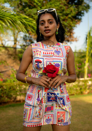 Model wearing printed co-ord set with sunglasses on head, holding flowers