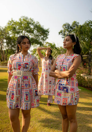 Three models standing in a garden wearing outfits with the same floral print in different styles