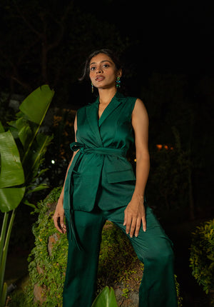 Model wearing a green co-ord set with tie-effect jacket in a night scene