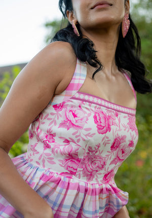 Side close-up of the model in a floral dress showing side profile and design detailing