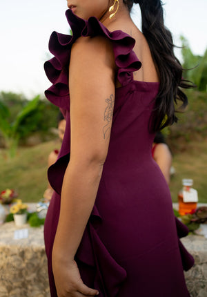 Side pose of the model showing the side view and ruffle details of the dress