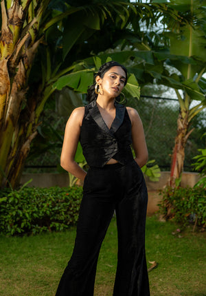 Model standing in the garden wearing a solid black co-ord set