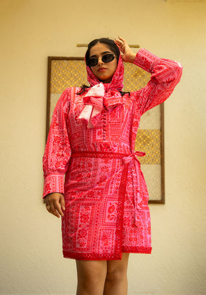 Model wearing a matching printed scarf and dress styled in a wrap-effect design