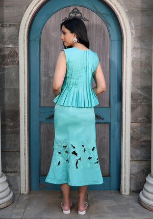Elegant aqua blue coord set featuring handcrafted pleats and floral cutwork detailing on a flowy summer skirt.