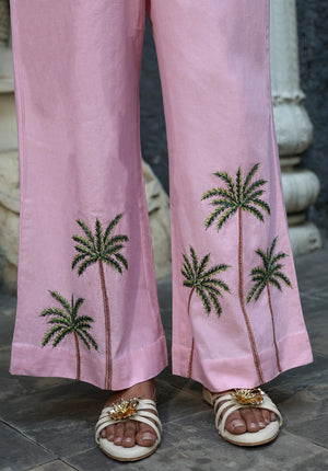 Close-up of blush pink wide-leg pants with palm tree embroidery detail near hem
urmish-ss26-palm-top-closeup