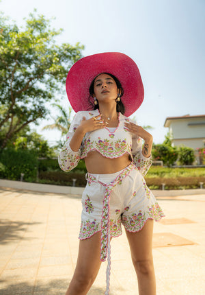 Model wearing V-neck top and matching belted shorts in a standing pose — relaxed and coordinated