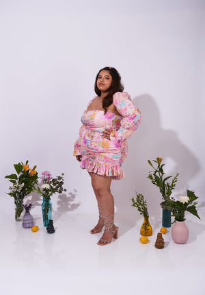 Side view of the Allora Skirt paired with a fitted bubble-sleeve top – perfect for chic styling.