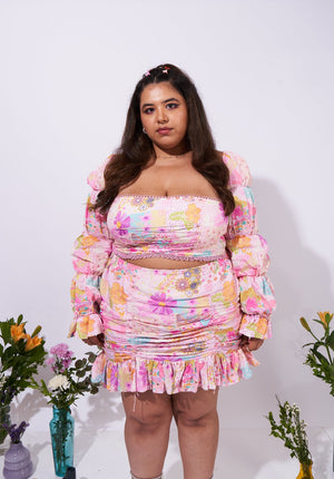 Front view of the Allora Skirt – ruffled hem, playful drawstrings, and vibrant floral print.