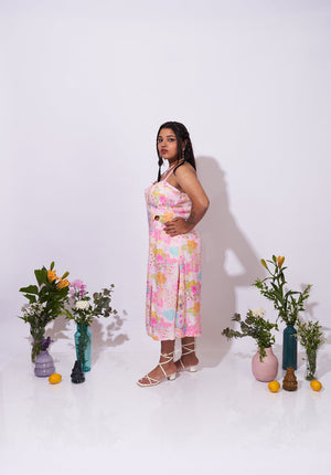 Side view of the Allora Dress – Feminine floral print with thigh-high slit