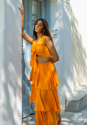 Elegant vacation-ready co-ord set featuring a breezy three-tiered ruffle skirt and a tie-up crop top – perfect for beach getaways and brunch styling.