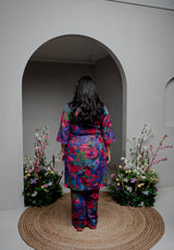 Rear view of the kurta's V-neckline and contrast piping, paired with straight pants.