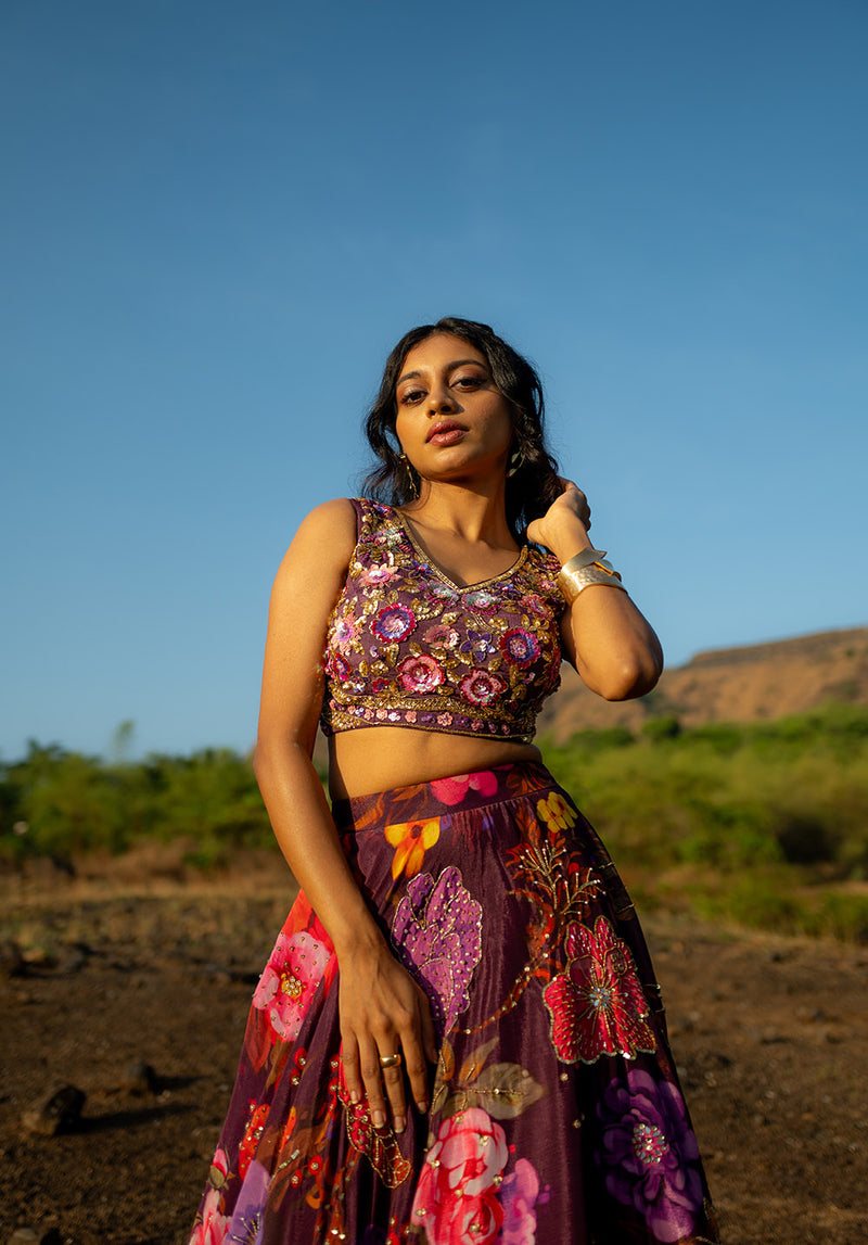 Delicate look of the lehenga set featuring a matching blouse and printed skirt styled for weddings or functions.