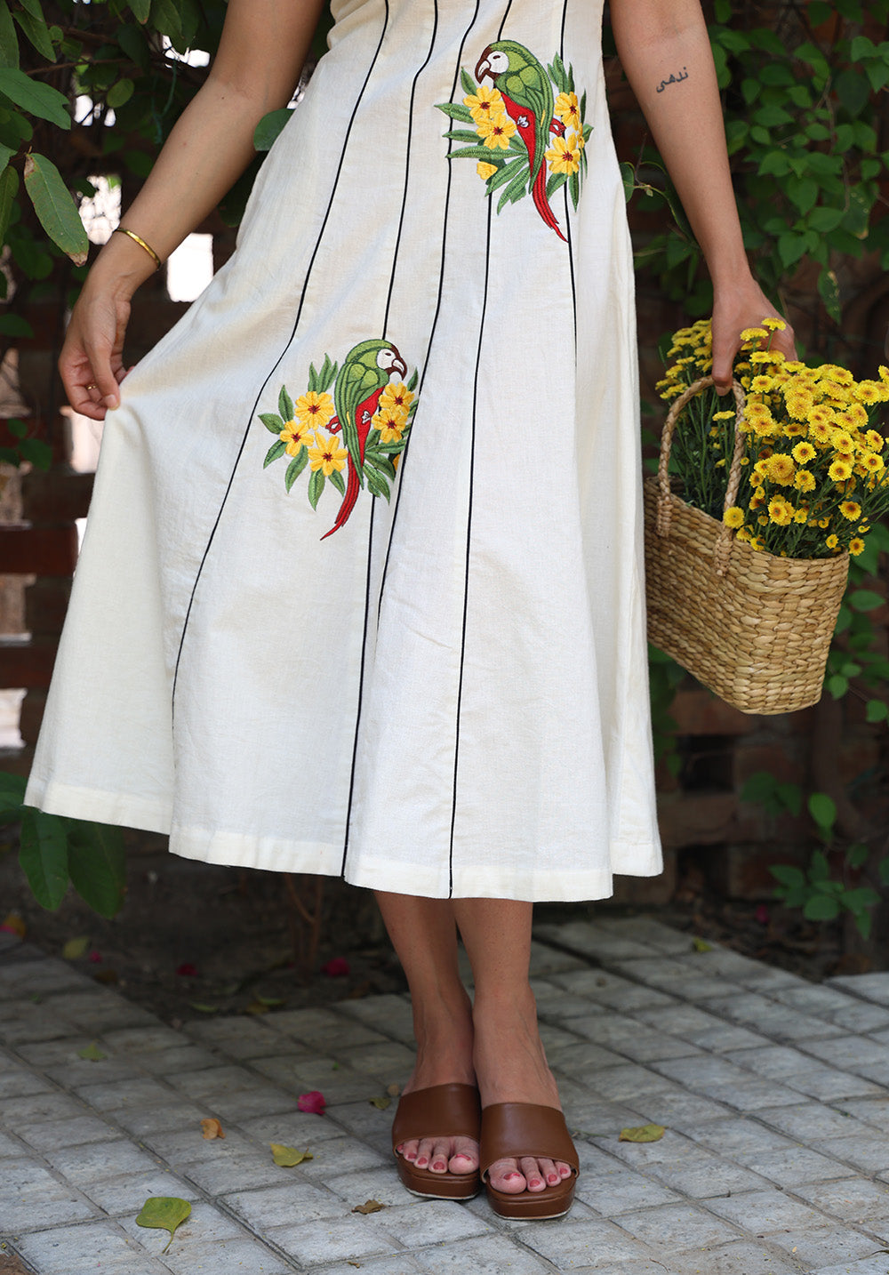 Angled front view of Parasio embroidered midi dress with tropical parrot detailing