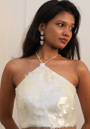 Close-up of Snowdrop Top showing hand-sewn oversized sequins and halter neckline.