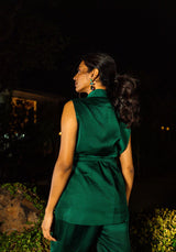 Back view of the model in a green sleeveless jacket