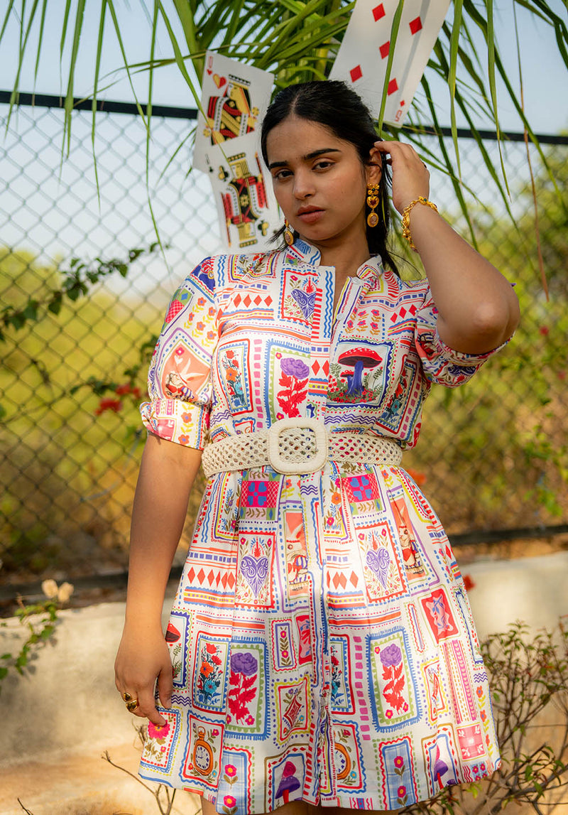 Model standing in a short dress with short sleeves, stand collar, and placket detailing, posing cutely
