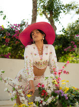 Model holding flowers while wearing a V-neck top and shorts — fresh and feminine garden look